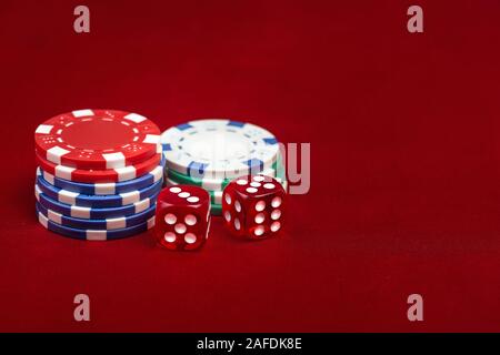 Dices and casino chips on red background. Gambling concept Stock Photo