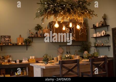Beautifully decorated kitchen table for Christmas. Christmas and New Year. Stock Photo