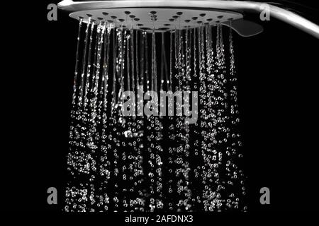 Water jets and drops from the shower. On a dark background closeup. Stock Photo