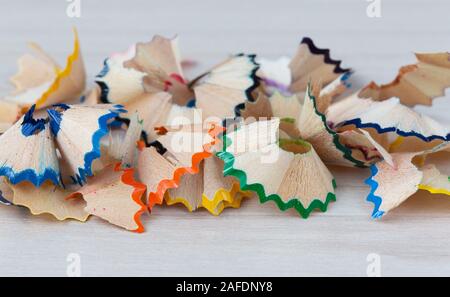 Shavings from sharpening colored pencils close-up on a light background Stock Photo