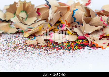 Shavings and dust from sharpening colored pencils close-up on a light background Stock Photo