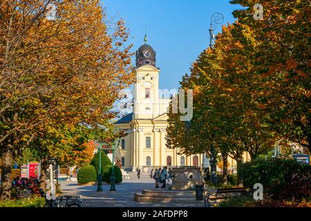 Great Reformed Church at the Kossuth Square with trees in autumn colours on a sunny day. Debrecen, Hungary. Stock Photo