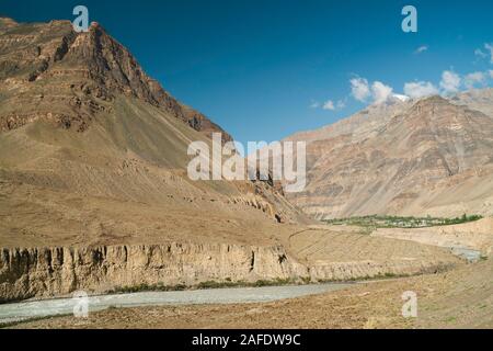 view of the Spiti river flowing in the Spiti valley through Himalaya mountains with Tabo town just visible in the distance in Himachal Pradesh, India. Stock Photo