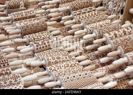 Hand-carved rolling pins at Krakow's Rynek Główny market. Traditional Polish folk art. Stock Photo
