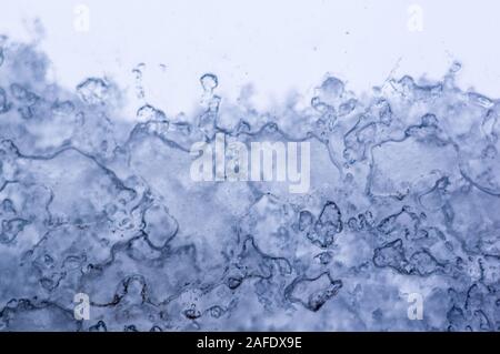 glass in the window covered with wet melting snow, close-up, macro Stock Photo