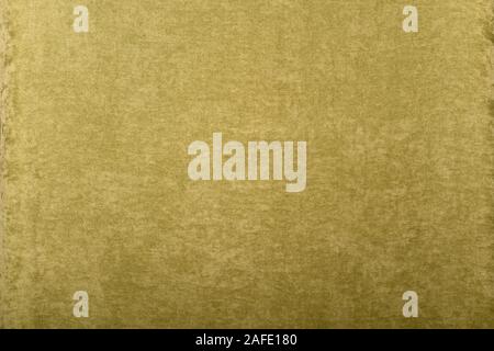 A green plush background of slightly crumpled, fleecy fabric, evenly laid out. Stock Photo