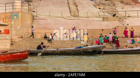 People and boats at the river Ganges at the Lalita Ghat in Varanasi, India Stock Photo