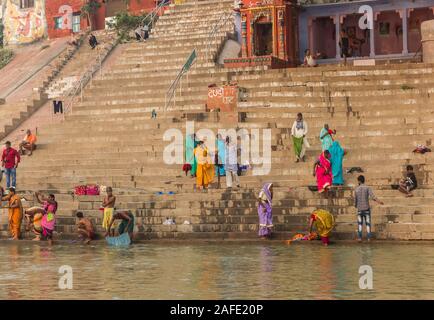 Colorful people at the stairs to the Ganges river in Varanasi, India Stock Photo