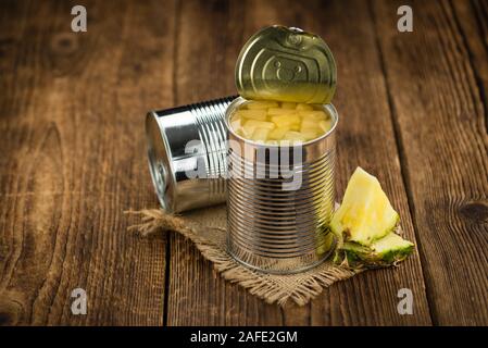 Fresh made Chopped Pineapple (preserved) on an old and rustic wooden table; selective focus; close-up shot Stock Photo