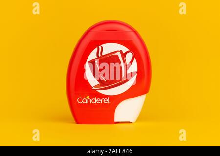 A Canderel artificial sweetener dispenser shot on a yellow background. Stock Photo