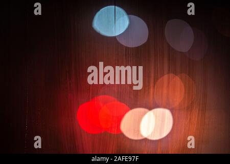 night street lights bokeh through wet glass, close-up with selective focus Stock Photo
