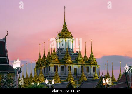 Top of the Loha Prasat chedi of the Buddhist temple Wat Ratchanatdaram Voravihara against the sunset sky. Bangkok, Thailand Stock Photo