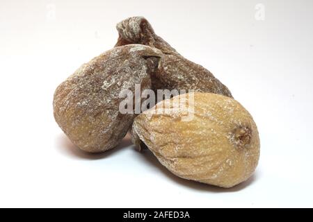 Image of three dried figs isolated on white background. Stock Photo