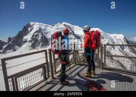 Two mountaineers look at Mont Blanc from the Aiguille du Midi platform, Chamonix, France Stock Photo