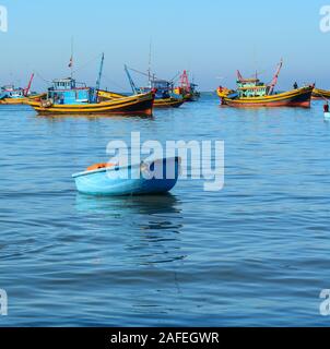 Phan Thiet, Vietnam - Mar 19, 2016. Fishing boats on blue sea in Phan Thiet, Vietnam. Phan Thiet has a bustling little fishing port with a harbor full Stock Photo