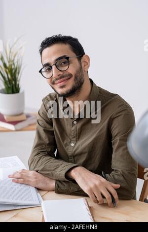 Happy young successful male employee or student in casualwear looking at you Stock Photo
