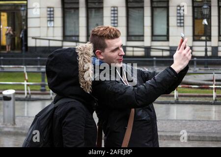 Young couple taking a selfie in front of Branderburg Gate in Berlin, Germany Stock Photo