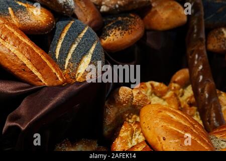 many rolls of different breads in the bakery restaurant Stock Photo