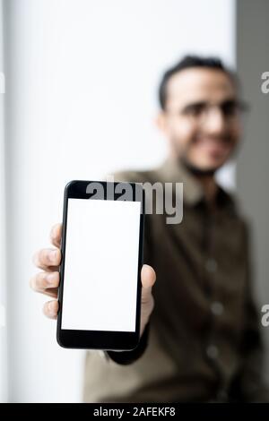 Smartphone with blank touchscreen in hand of young contemporary businessman Stock Photo