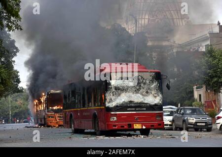 New Delhi, India. 15th Dec, 2019. Photo taken on Dec. 15, 2019 shows passenger buses in flames in New Delhi, India. Protesters in Indian capital Sunday set ablaze several vehicles including three buses during their protest over new citizenship law in country, officials said. Credit: Str/Xinhua/Alamy Live News Stock Photo