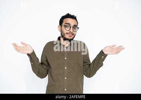 Young puzzled businessman in eyeglasses looking at you while spreading his hands Stock Photo