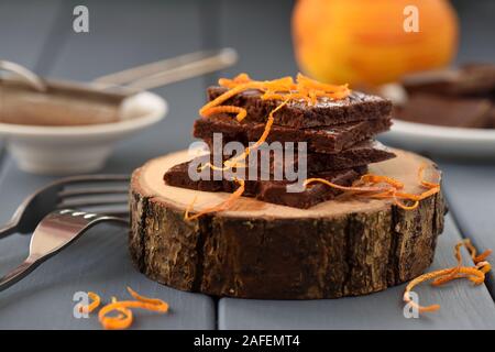 Craft chocolate bars decorated with orange peels on wood slabs closeup Stock Photo