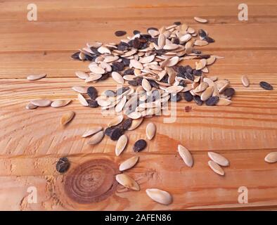 Watermelon and melon seeds on wooden background Stock Photo