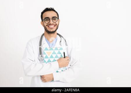 Happy young successful clinician with stethoscope, clipboard and pen Stock Photo