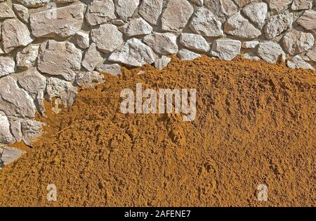 A lot of Construction sand near a wall background Stock Photo