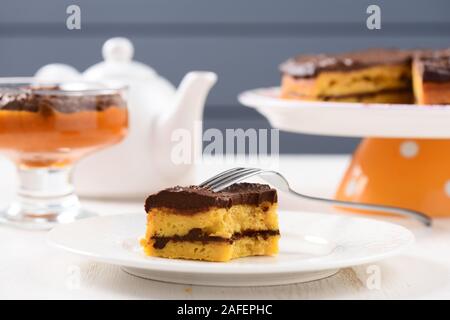 Tea table with teaware, low callorie pumpkin dessert and homemade layered pumpkin cake with chocolate ganache horizontal Stock Photo
