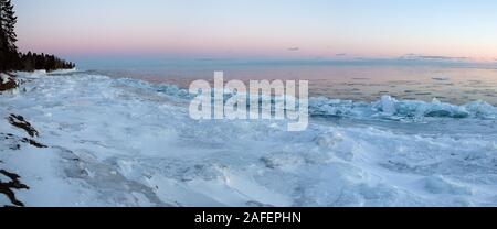 A winter sunset panorama landscape along the North Shore of Lake Superior with ice shards piling up in Cook County, Minnesota Stock Photo