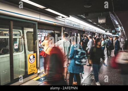 HongKong, China - November, 2019:  People using subway train at  MTR station / metro train station in HongKong Stock Photo