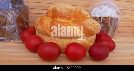 Easter red eggs and homemade bread and cakes. Easter concept Stock Photo