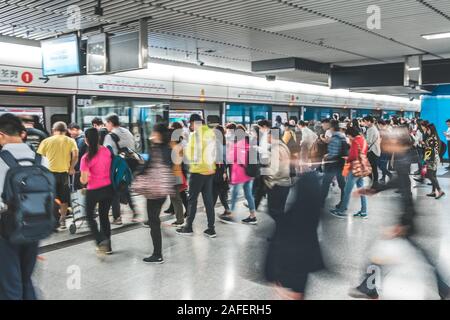 HongKong, China - November, 2019:  People using subway train at  MTR station / metro train station in HongKong Stock Photo