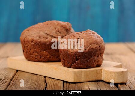 Pair of homemade chocolate cakes on blue background horizontal Stock Photo