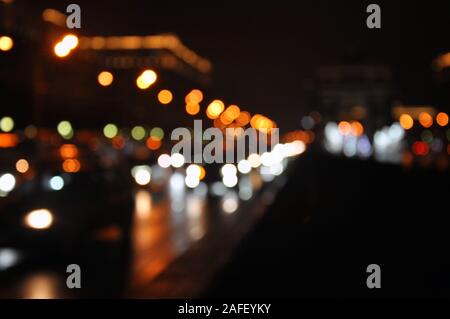 Traffic lights of the night city road. Rainy autumnal evening Stock Photo