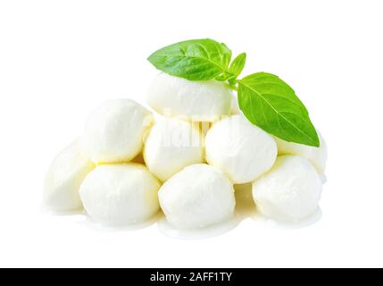 Heap of mini mozzarella cheese balls and basil isolated on white background. Healhy mediterranean cuisine and vegetarian food. Front view. Stock Photo