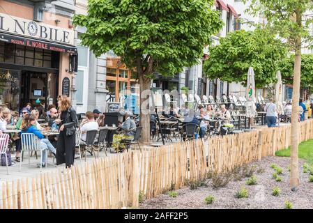 Ixelles, Brussels / Belgium - 05 31 2019: People eating, talking and drinking at sunny terraces of the Fernand Cocq square Stock Photo