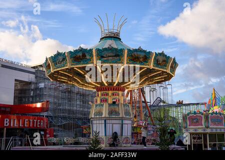 PARIS, FRANCE - DECEMBER 14, 2019: Beautiful swing ride carousel in  a big funfair held on Place de la Fontaine aux Lions, at The Parc de la Villette. Stock Photo