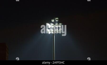 rugby stadium lights during game over dark blue sky in england uk Stock Photo