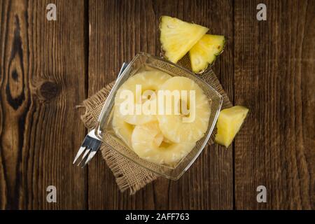 Preserved Pineapple Rings on a vintage background as detailed close-up shot, selective focus Stock Photo