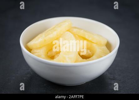 Preserved Pineapple Rings on a vintage slate slab as detailed close-up shot; selective focus Stock Photo