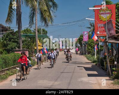 School children on their way home from school at lunchtime on a sunny day - taken on Silk Island / Koh Dach, Phnom Penh, Cambodia Stock Photo