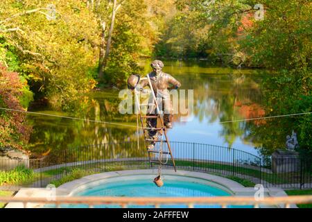 Old Westbury, New York, USA. 19th Oct, 2019. Charlie Chaplin, a bronze resin sculpture of the English comic actor climbing a ladder suspended over a reflecting pool overlooking a pond on the Old Westbury Gardens estate, is one of the Polish sculptor Jerzy KÄ™dziora (Jotka) Balance in Nature outdoor sculptures seen during a tour during Closing Reception for the exhibit. Credit: Ann Parry/ZUMA Wire/Alamy Live News Stock Photo