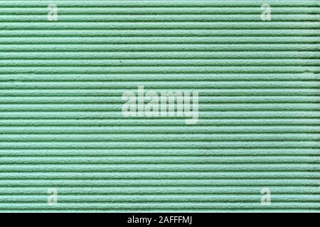 Green relief striped stone wall. texture strip wall, surface, background, decorative plaster Stock Photo