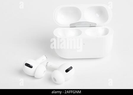 Vidalia, Georgia / USA - December 14, 2019 - A studio product shot of the Apple AirPods Pro buds with its open charging case set on a plain light colo Stock Photo