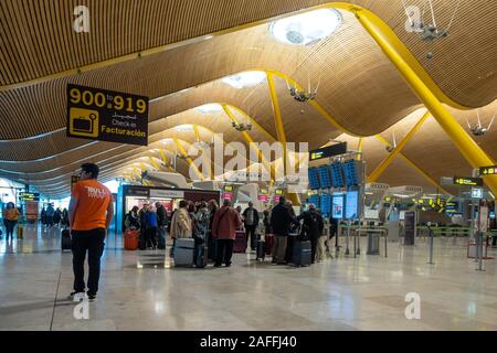 Passengers wait to check in in Madrid-Barajas Adolfo Suárez Airport in Madrid, Spain. Stock Photo