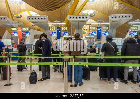 Passengers queue at check-in at terminal 4 of Madrid-Barajas Adolfo Suárez Airport in Madrid, Spain. Stock Photo