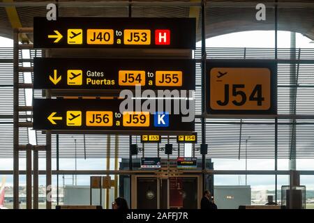 Signs in Madrid-Barajas Adolfo Suárez Airport in Madrid, Spain direct people to the appropriate departure gates. Stock Photo