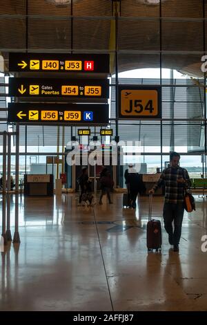 Signs in Madrid-Barajas Adolfo Suárez Airport in Madrid, Spain direct people to the appropriate departure gates. Stock Photo